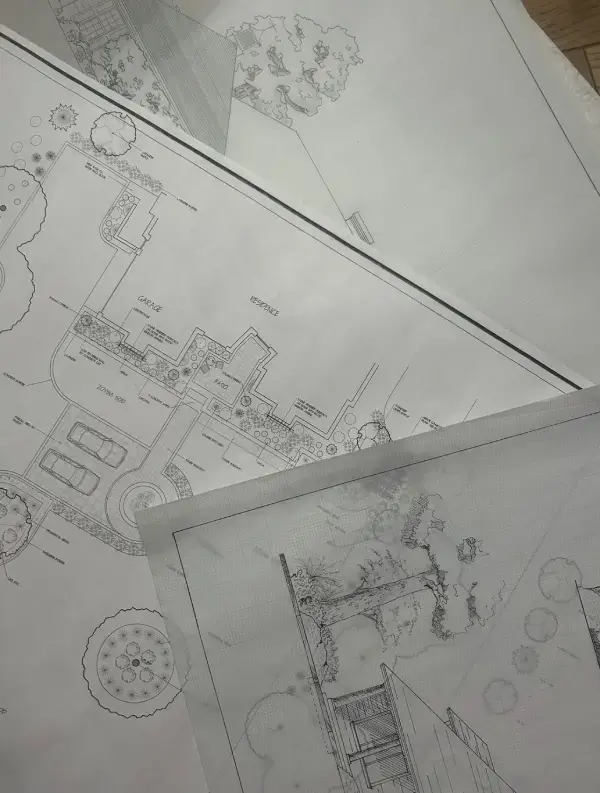 Architectural blueprints spread out on a table.